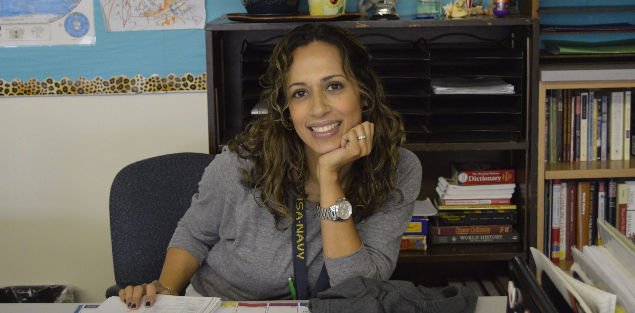 Teacher leaning on desk